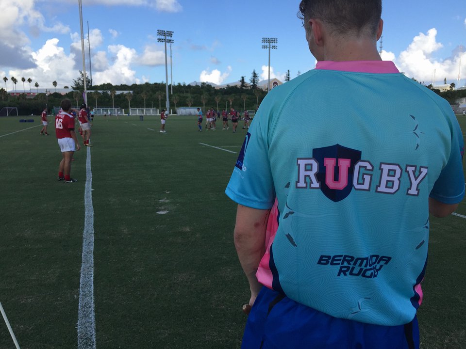 Man standing with his back to the camera wearing a URugby jersey